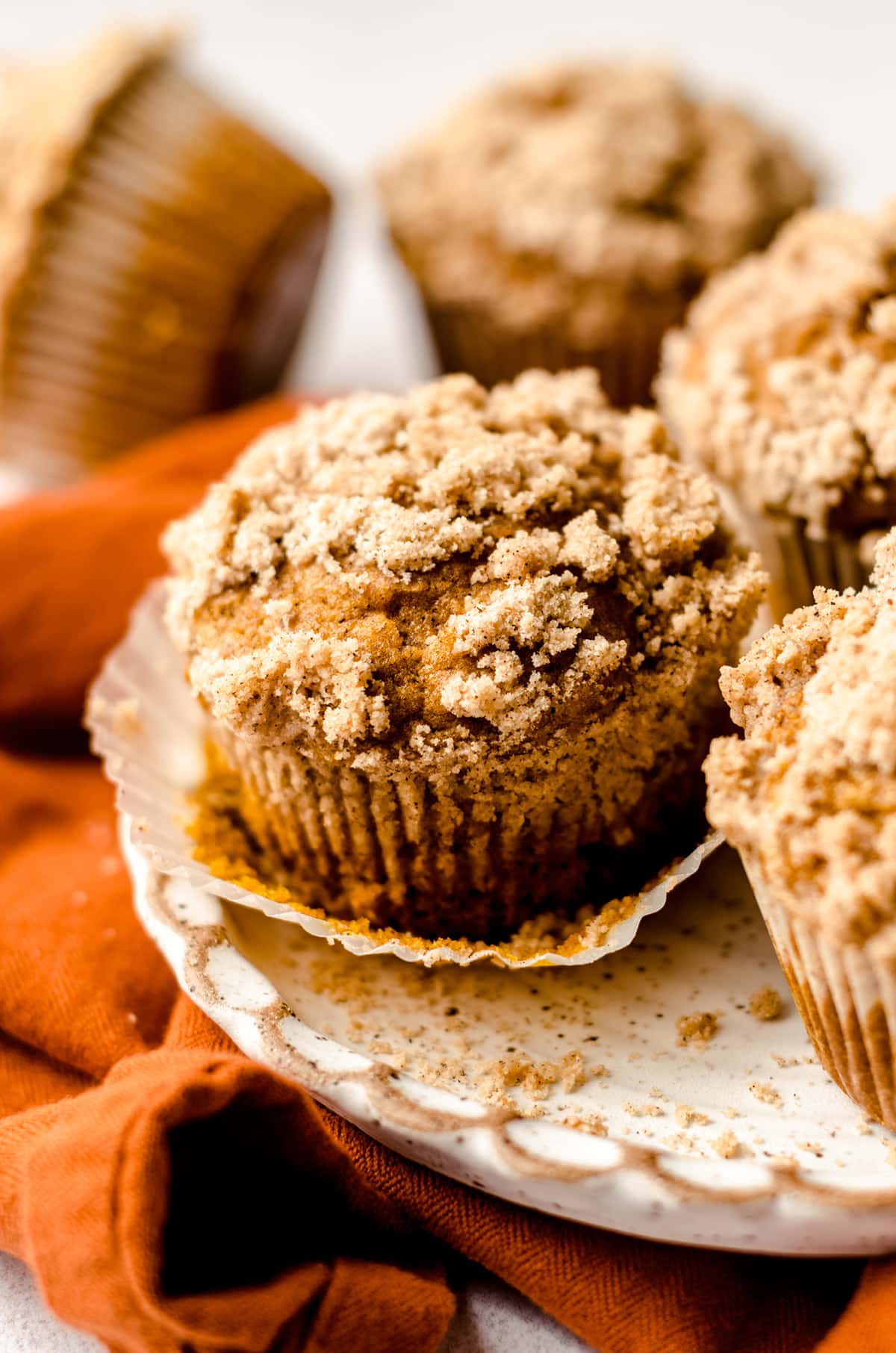unwrapped pumpkin muffin on a plate