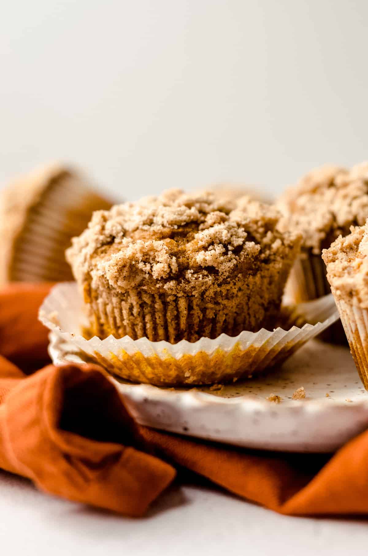 unwrapped pumpkin muffins on a plate
