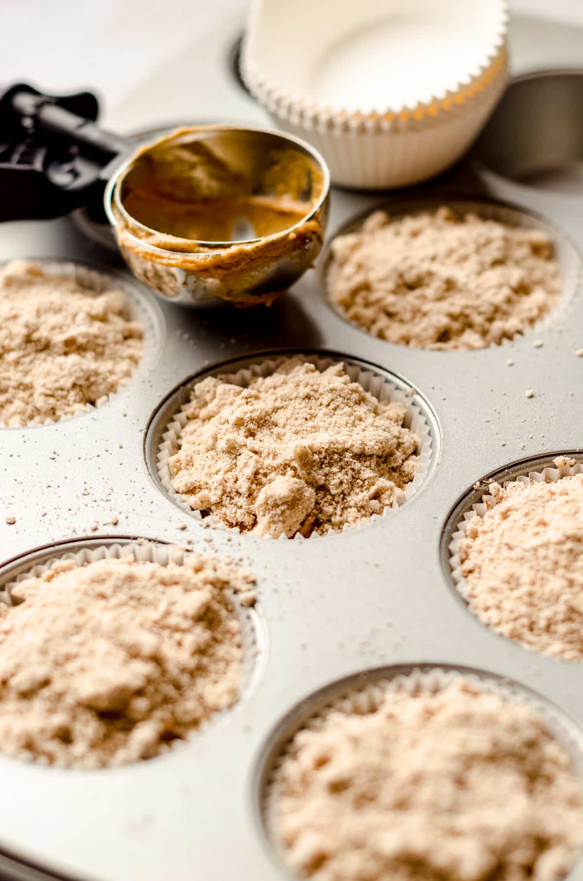 pumpkin streusel muffin batter in a muffin pan ready to bake