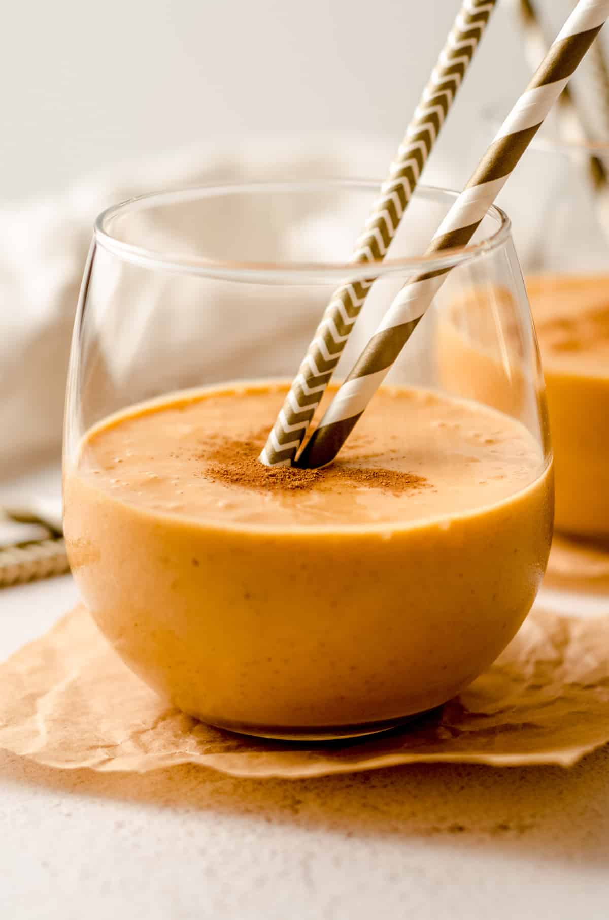 pumpkin pie smoothie in a glass with straws