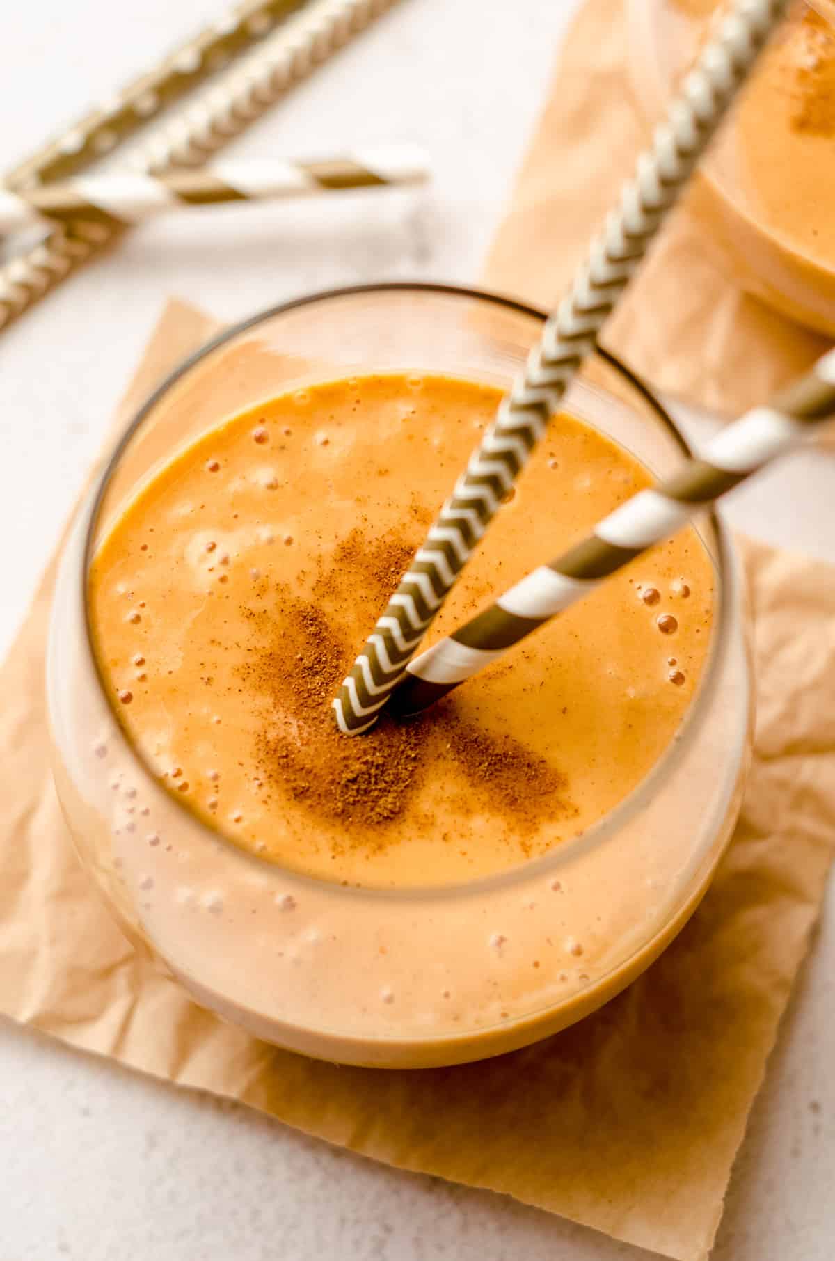 pumpkin pie smoothie in a glass with straws