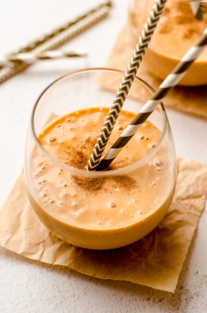 pumpkin pie smoothie in a glass with straws