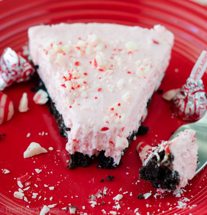 No Bake Candy Cane Crunch Pie: Creamy, minty pie studded with chopped Candy Cane Kisses all on top of a crunchy Oreo cookie crust.