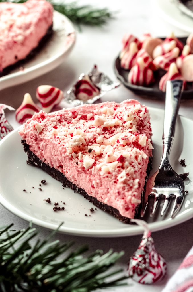 A slice of no bake peppermint pie on a plate with a fork.