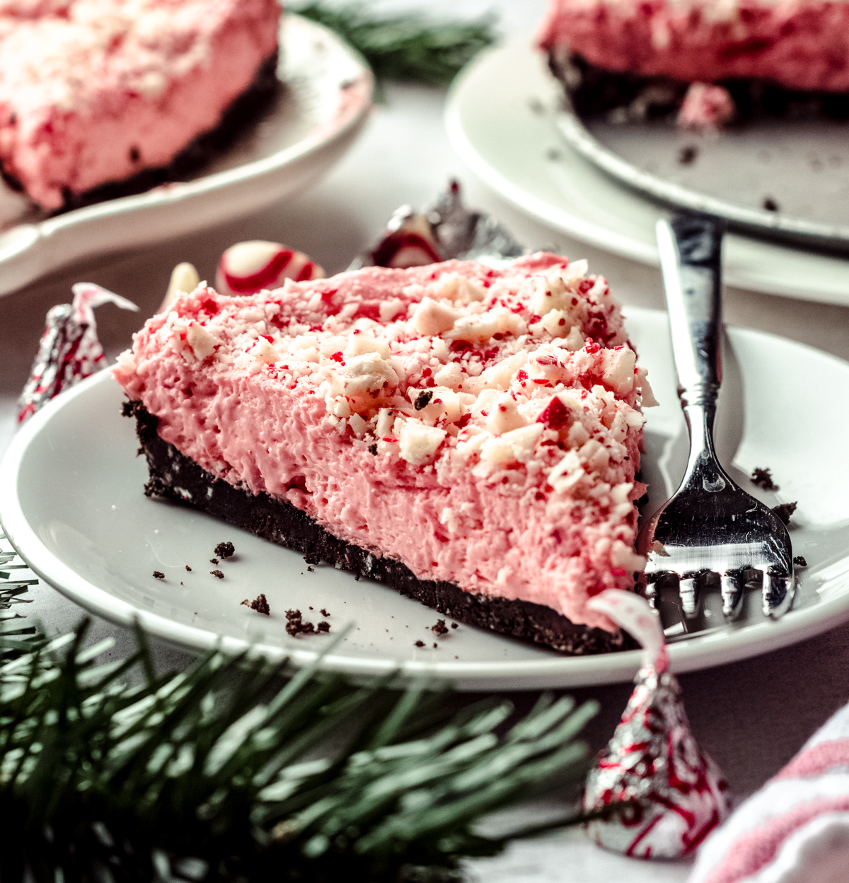 A slice of no bake peppermint pie on a plate with a fork.