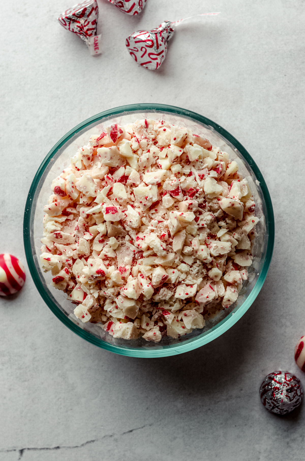 Aerial photo of a bowl of chopped candy cane Hershey's Kisses.