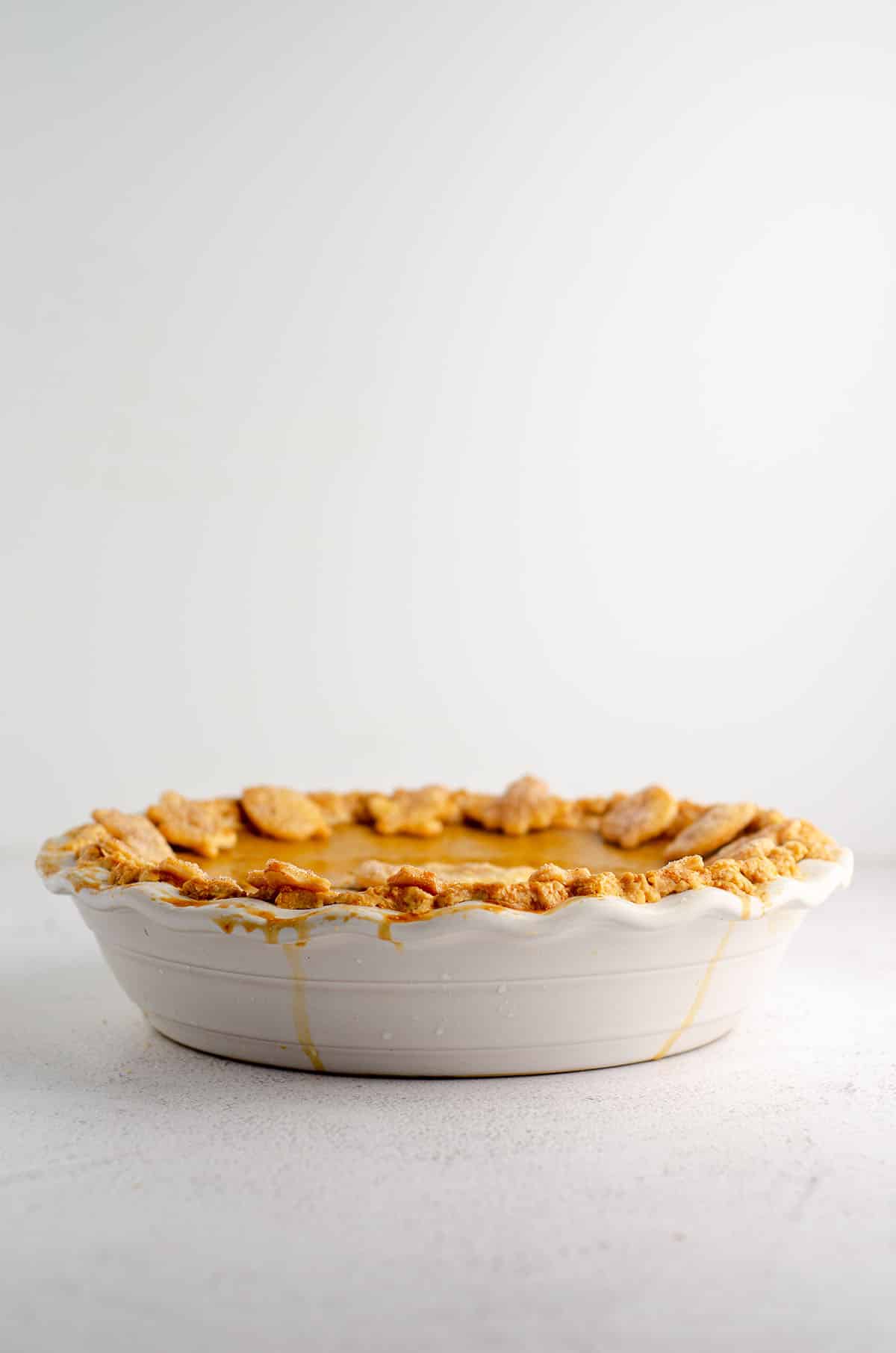 pumpkin pie in a white pie dish