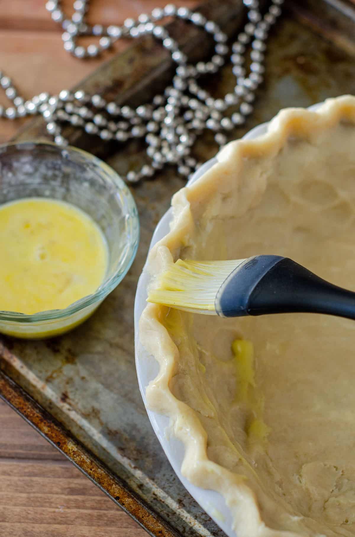 brushing a pie crust with an egg wash