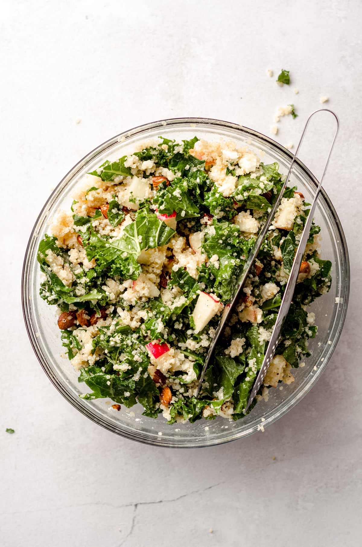 aerial photo of apple, quinoa, and almond kale salad in a bowl