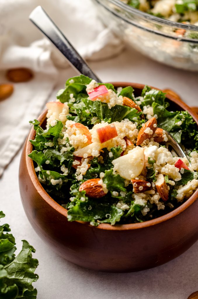 apple, quinoa, and almond kale salad in a bowl