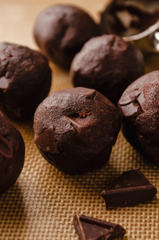 Chocolate cayenne cookie dough balls on a baking sheet.
