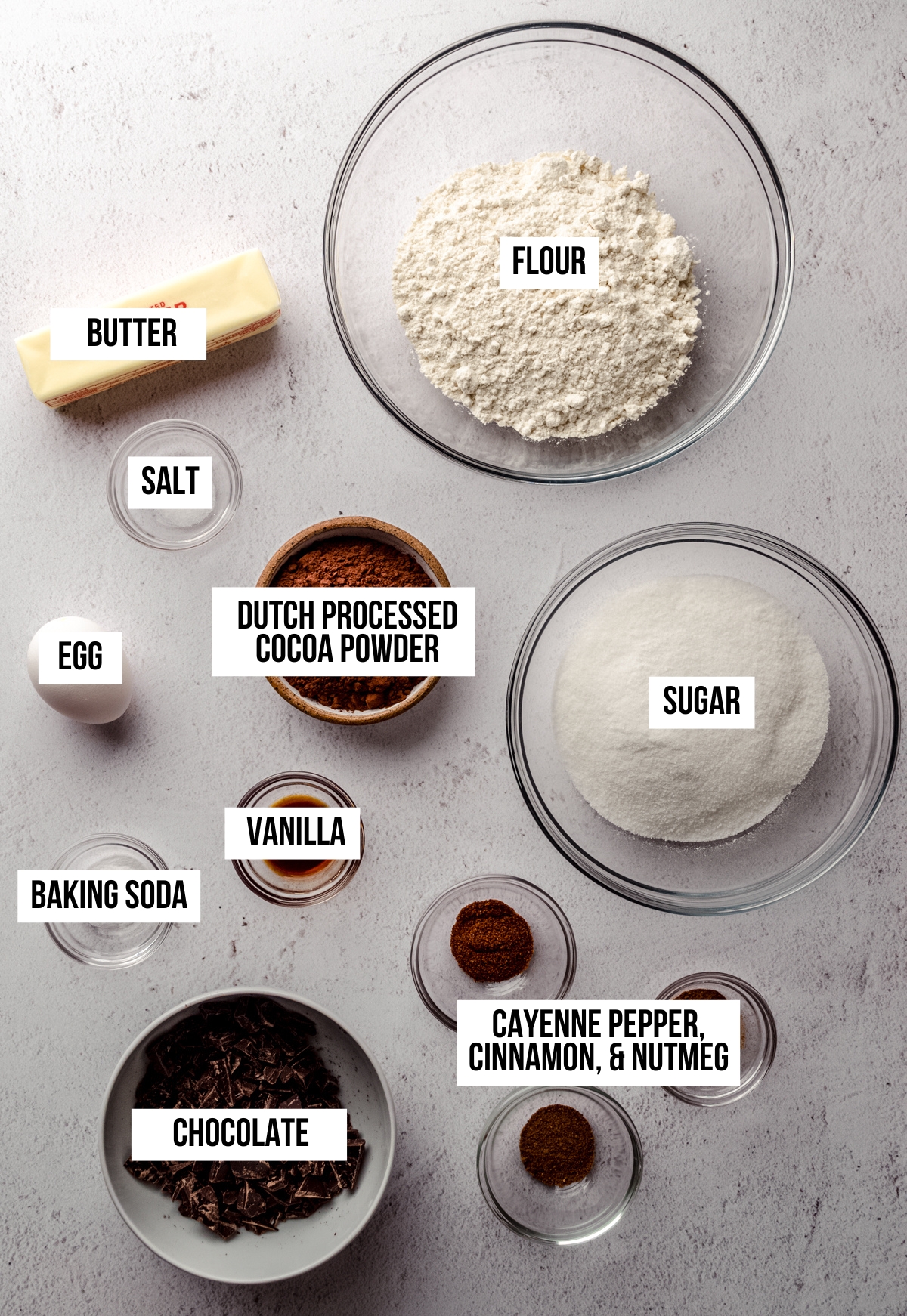 Arial photo of ingredients to make chocolate cayenne cookies with text overlay labeling each ingredient.