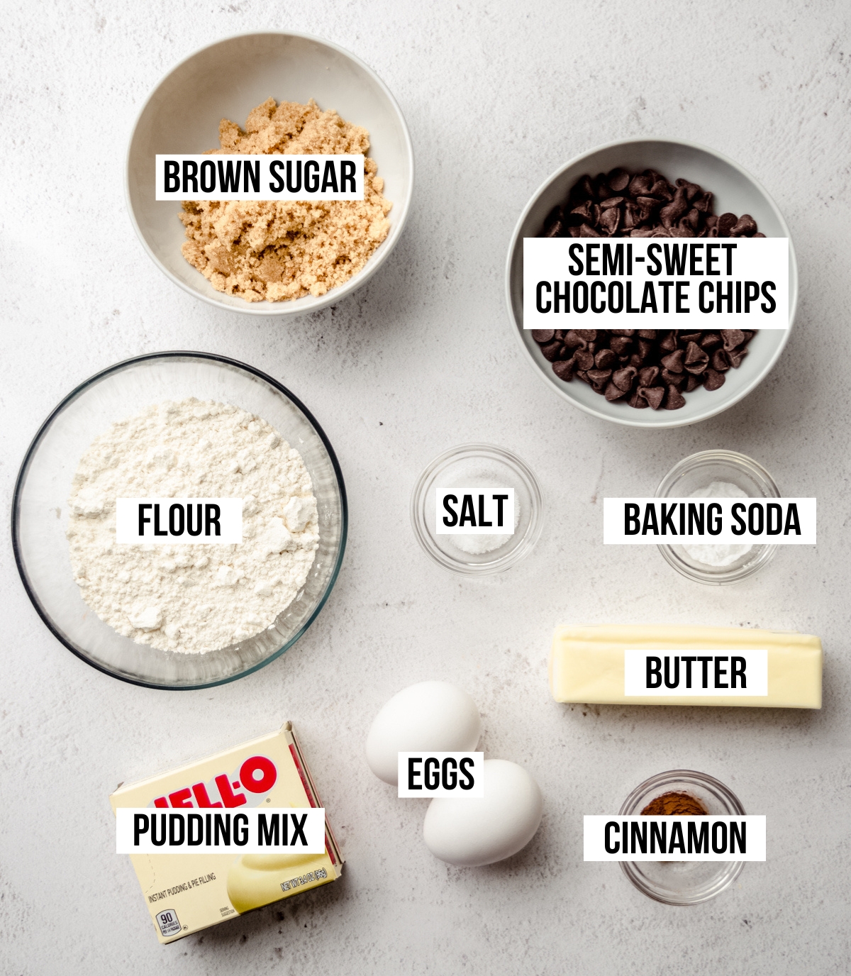 Aerial photo of ingredients to make chocolate chip snickerdoodle cookies with text overlay labeling each ingredient.