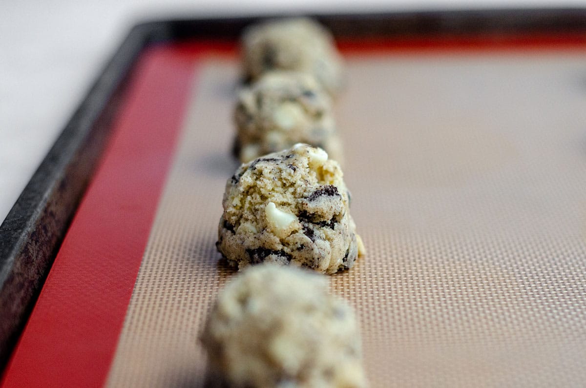cookies and cream cookie dough on a baking sheet ready to bake