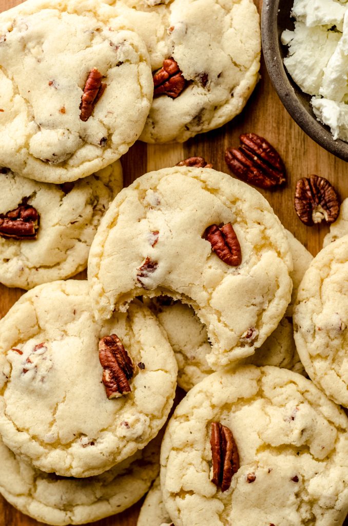Aerial photo of maple pecan goat cheese sugar cookies. A bite has been taken out of the one on the top.