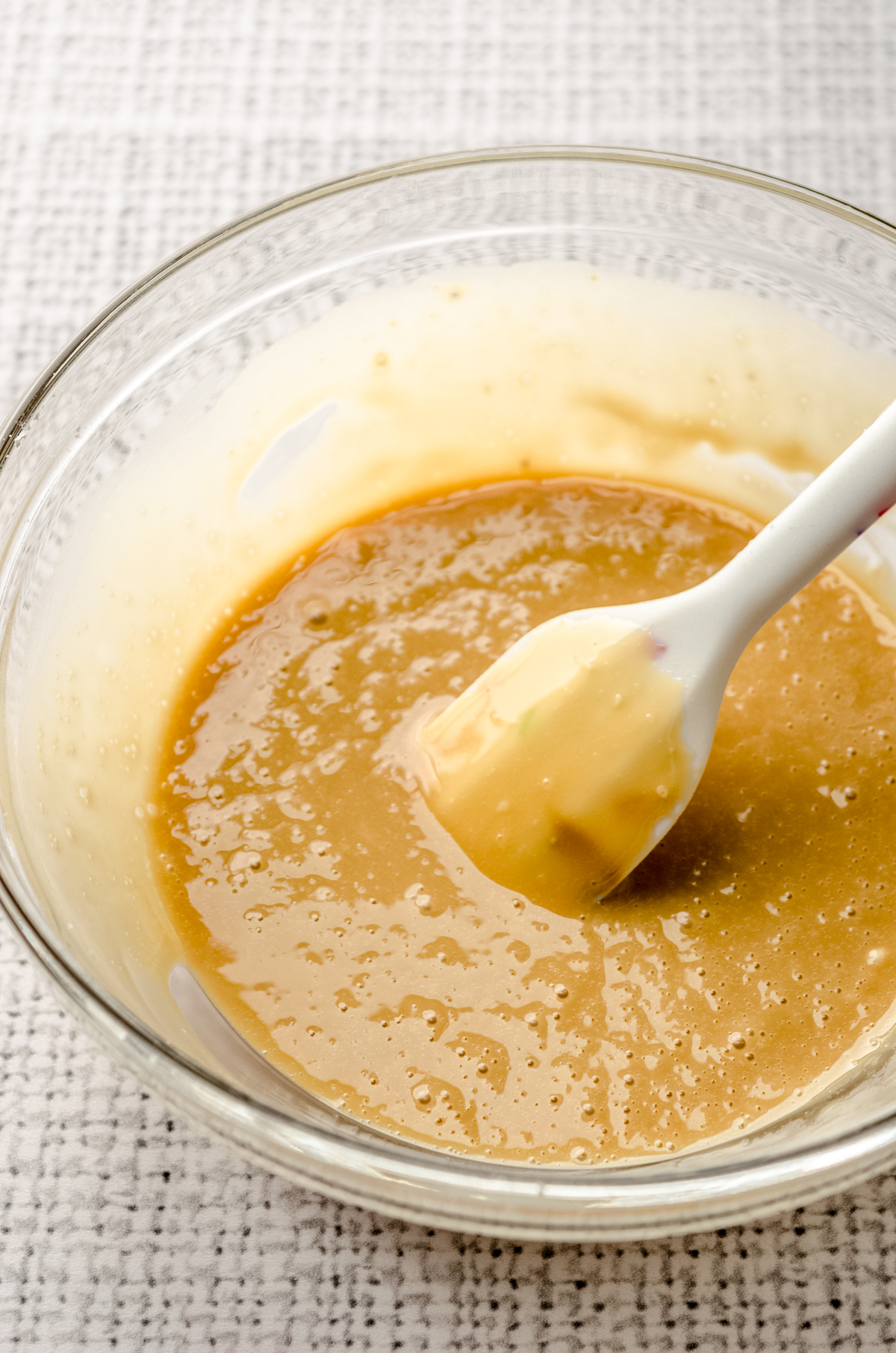 A bowl of molasses icing with a spatula.