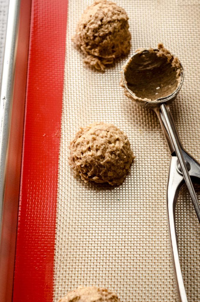 Oatmeal cookie dough balls on a baking sheet.