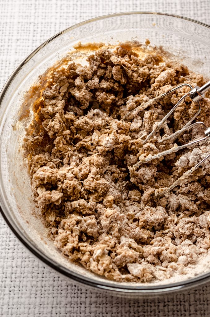 Aerial photo of ingredients in a bowl to make molasses iced oatmeal cookies.