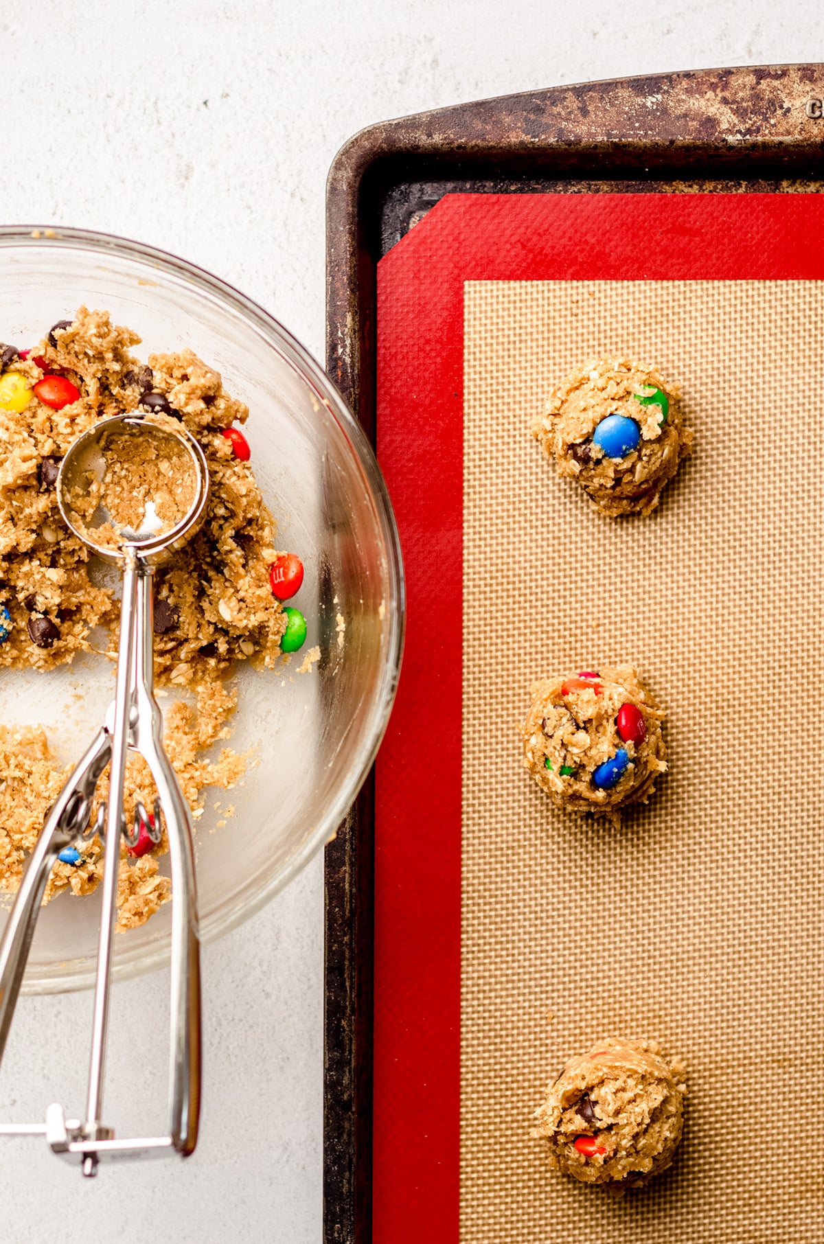 monster oatmeal cookie dough balls on a baking sheet