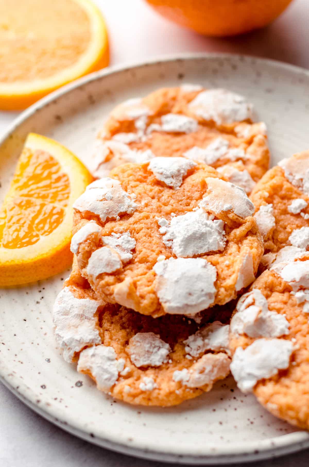 orange creamsicle cookies on a plate with orange slices