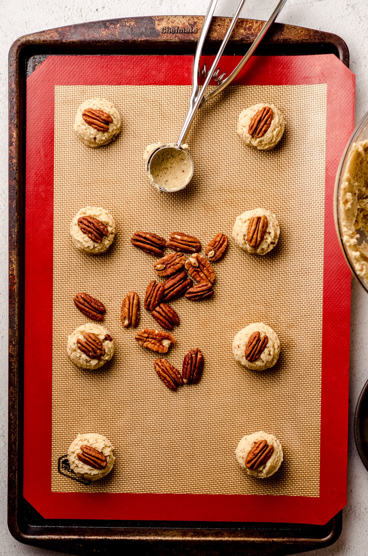 aerial photo of flour pecan sandies on a baking sheet ready to bake