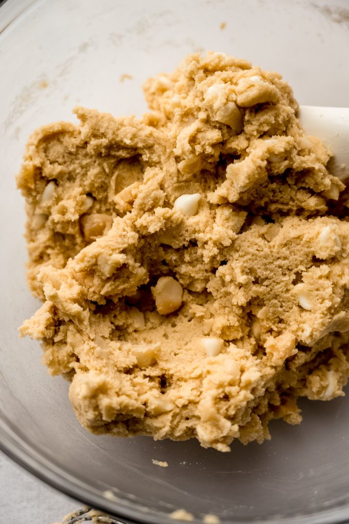 White chocolate macadamia nut cookie dough in a bowl.