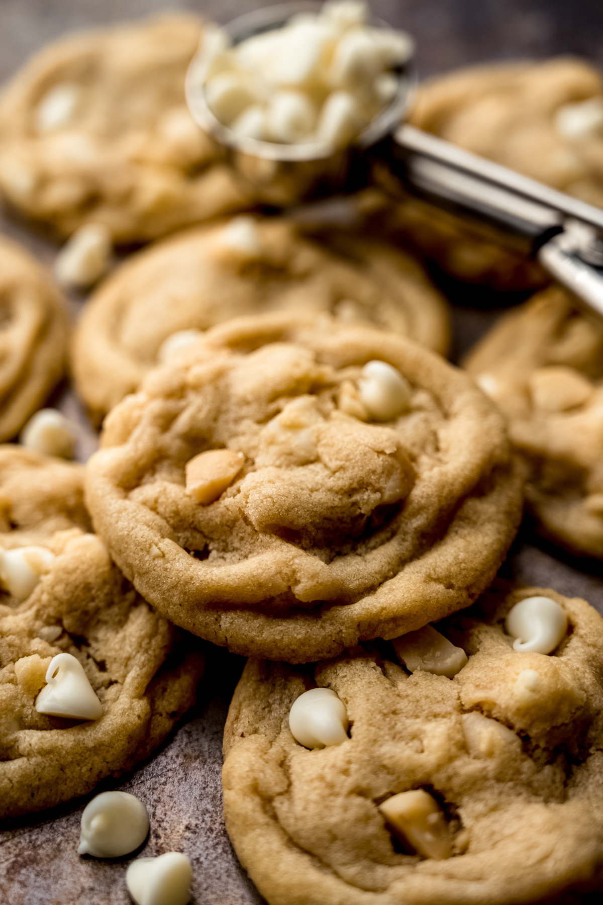 White chocolate macadamia nut cookies on a surface.