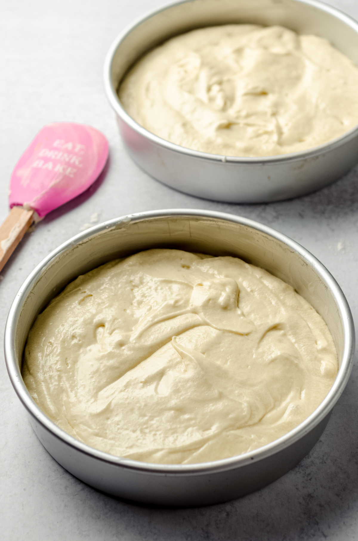Yellow cake batter in two 8" round cake pans.