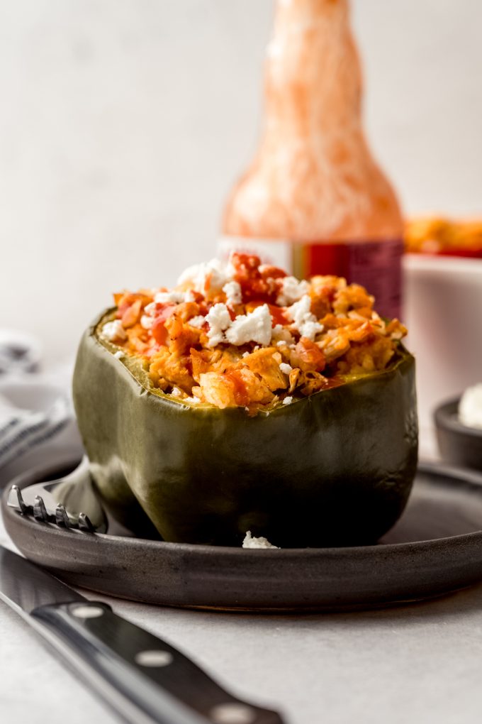 A buffalo chicken stuffed pepper on a plate with a fork.