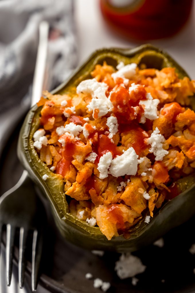 A buffalo chicken stuffed pepper on a plate with a fork.