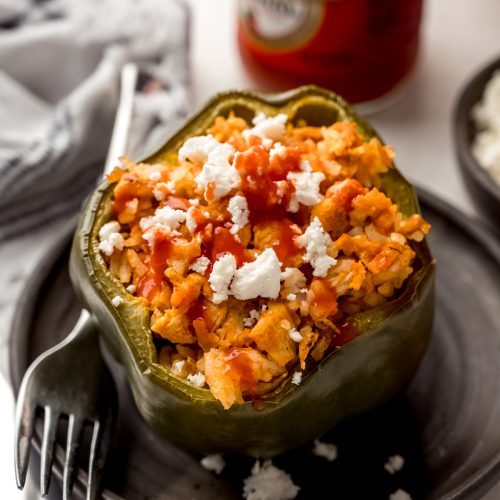 A buffalo chicken stuffed pepper on a plate with a fork.