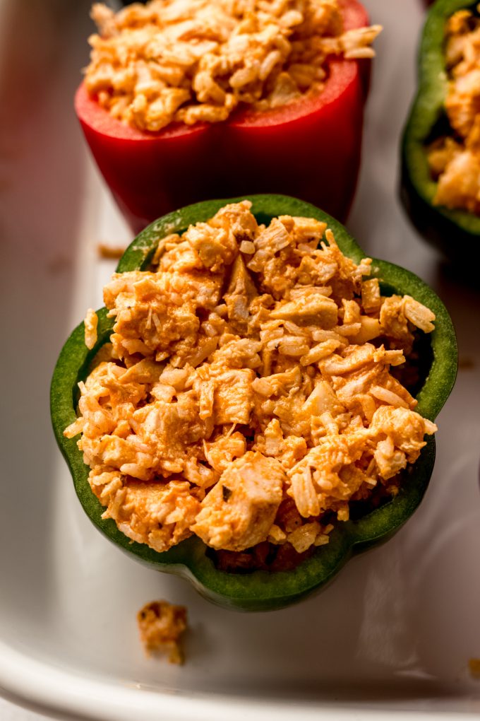 A buffalo chicken stuffed pepper in a baking dish.