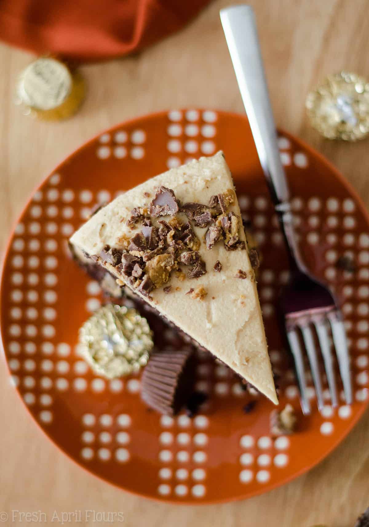 slice of dark chocolate cake with peanut butter frosting on a plate with a fork