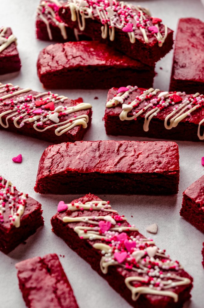 Red velvet biscotti on a surface.