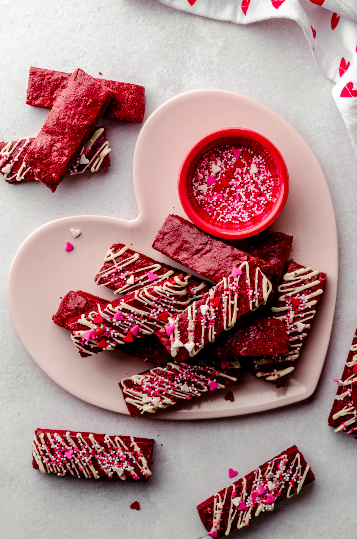 Aerial photo of red velvet biscotti on a heart shaped plate.