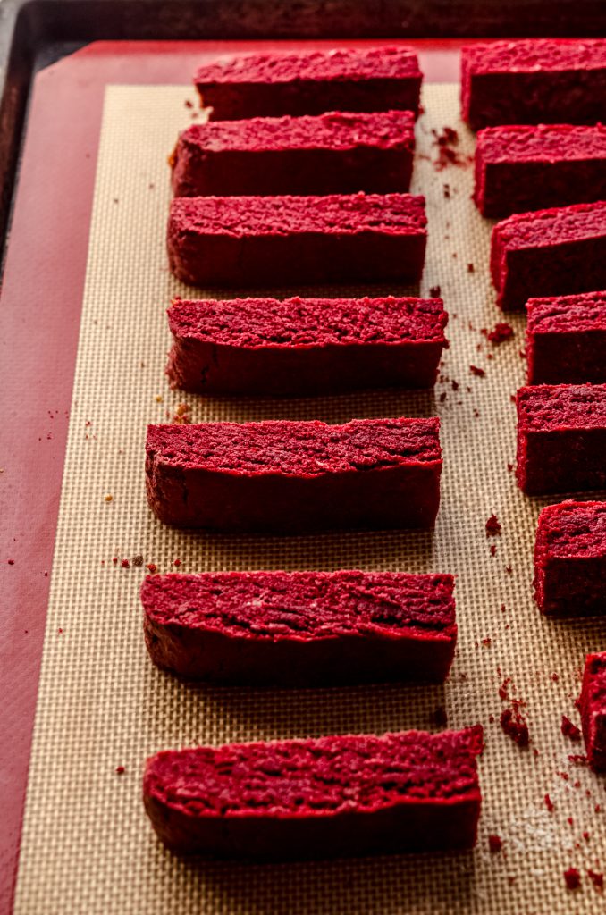 Red velvet biscotti on a baking sheet.