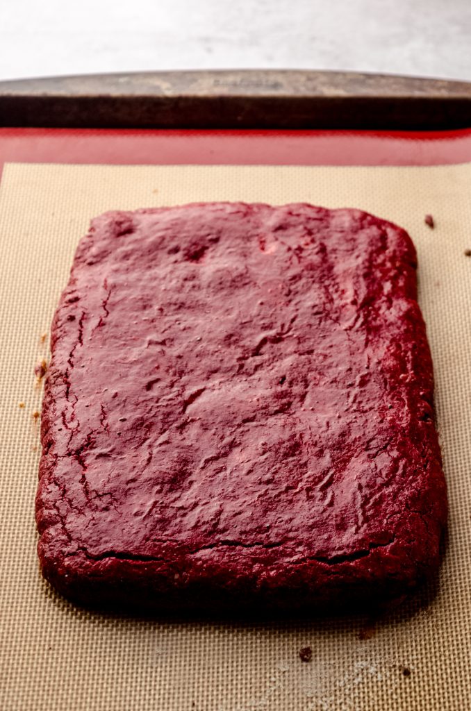 A red velvet biscotti slab of dough with an egg wash.