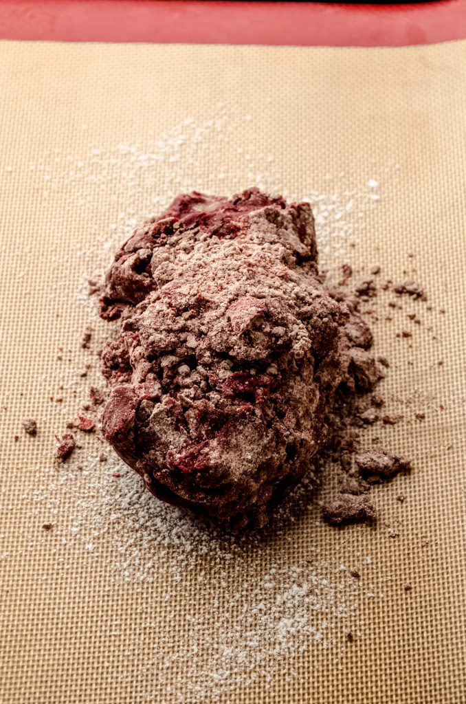 Dough for red velvet biscotti on a baking sheet.