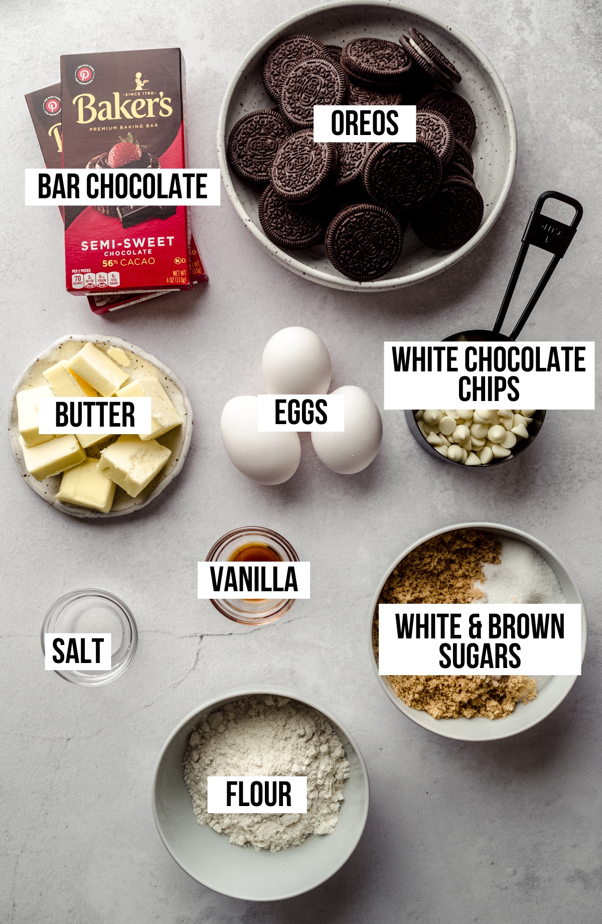 Aerial photo of ingredients to make cookies and cream brownies with text overlay labeling every ingredient.