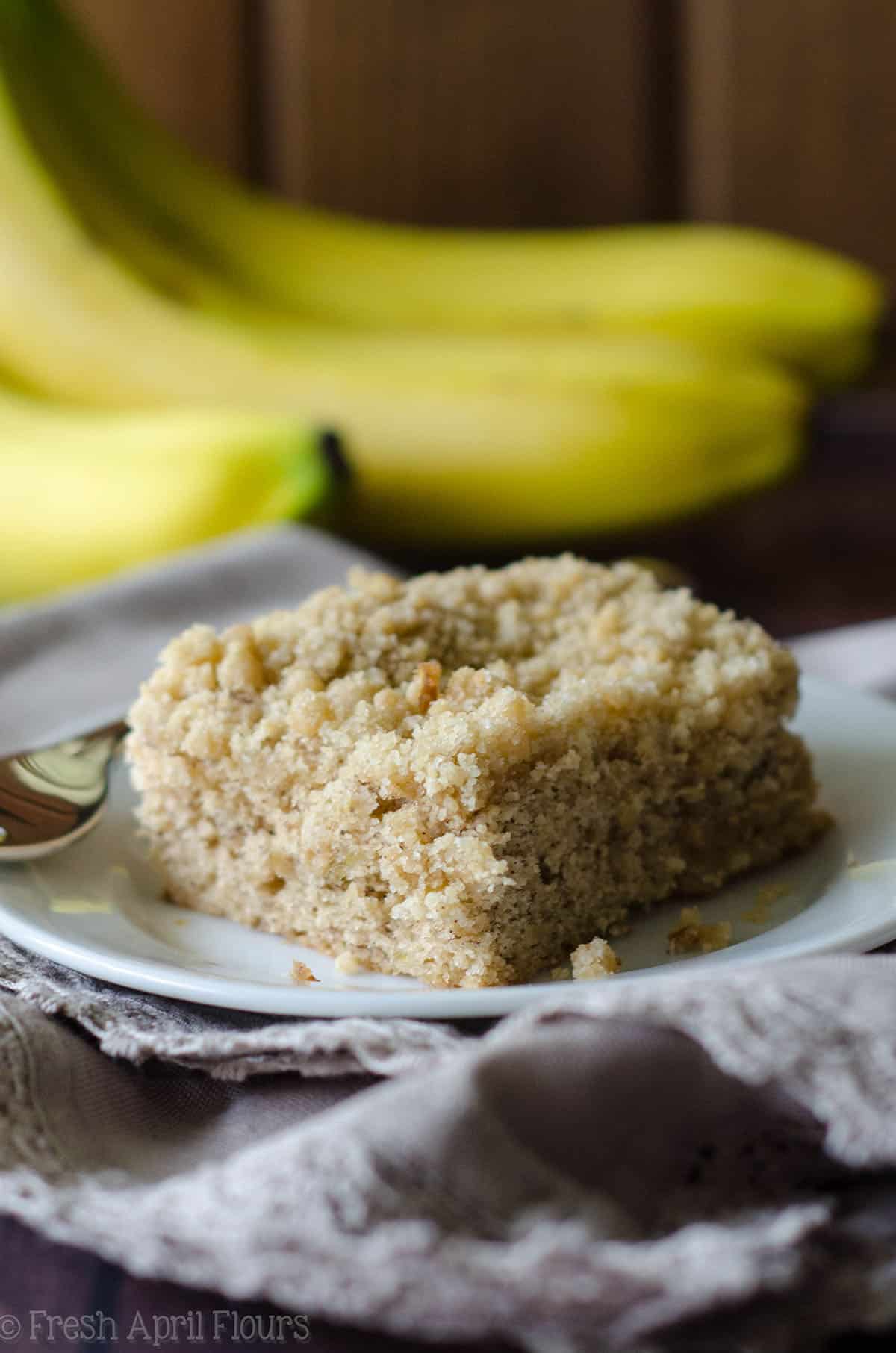 banana crumb snack cake on a white plate