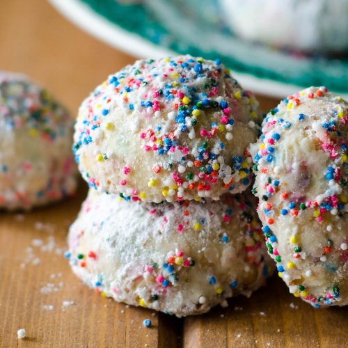 Funfetti Snowballs: Buttery, melt-in-your-mouth shortbread cookies filled with colorful sprinkles and rolled in powdered sugar.