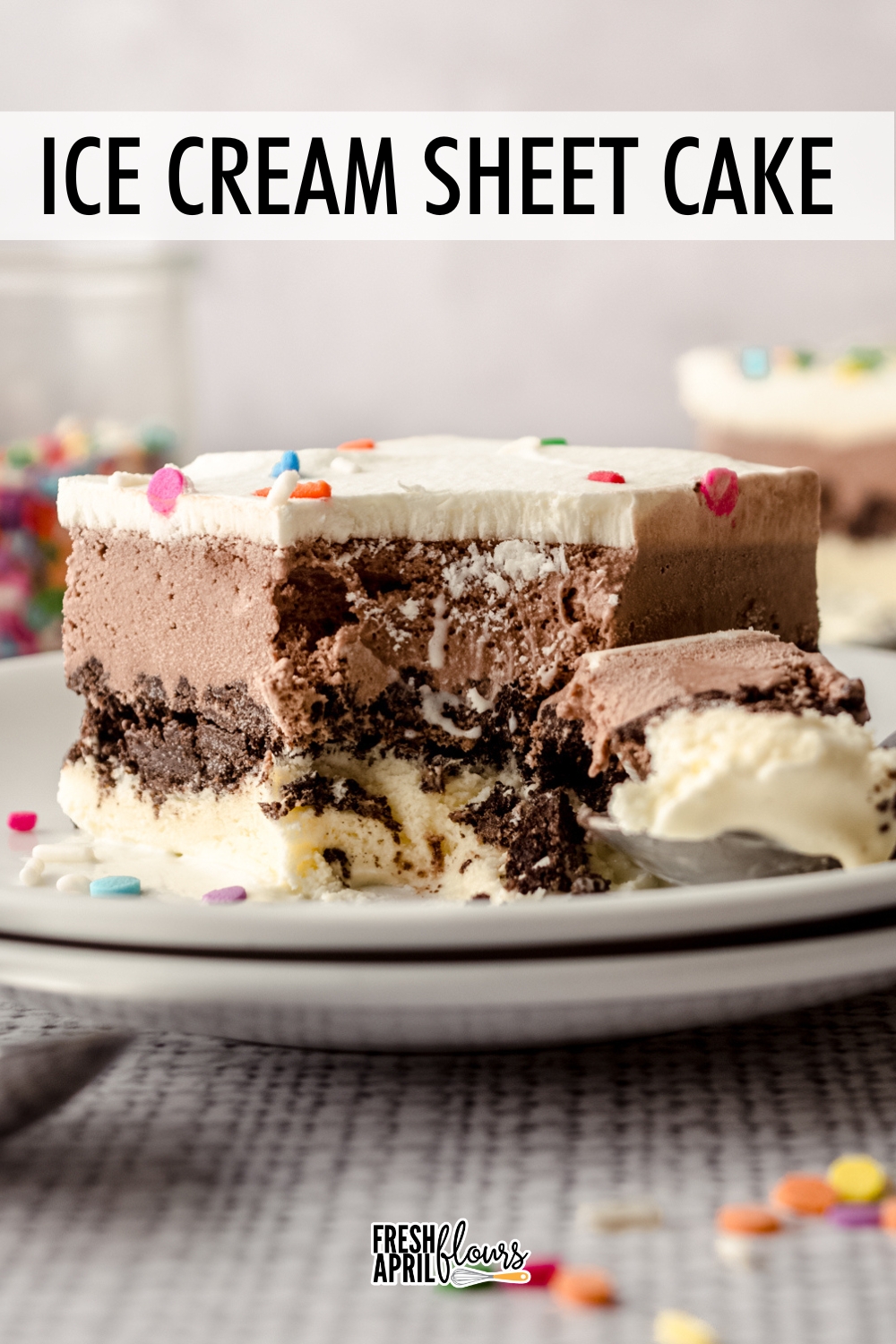 This easy recipe for homemade ice cream cake features two ice cream flavors of your choice, a crunchy cookie layer right in the middle, and homemade whipped cream and sprinkles on top. This no bake dessert makes a great make-ahead option since it needs to to freeze for at least 12 hours before serving.  via @frshaprilflours