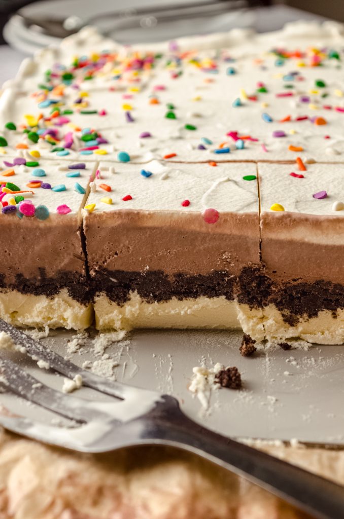 The cross-section of an ice cream sheet cake in a baking dish.