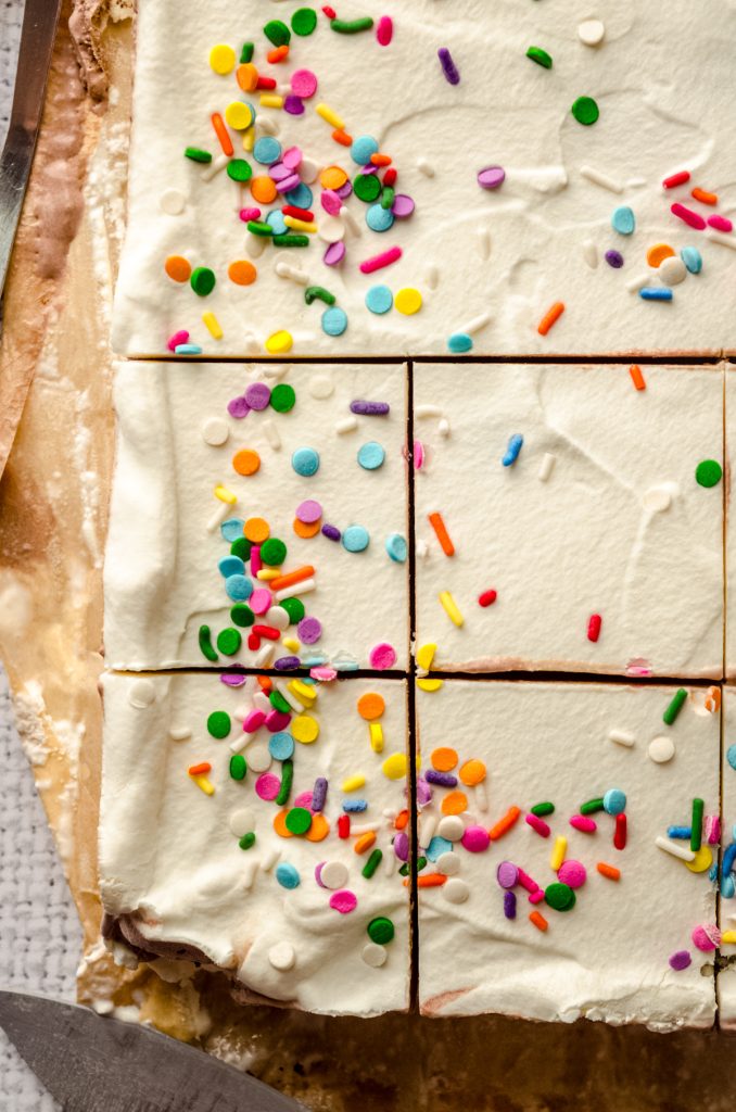 Aerial photo of an ice cream sheet cake that has been sliced.