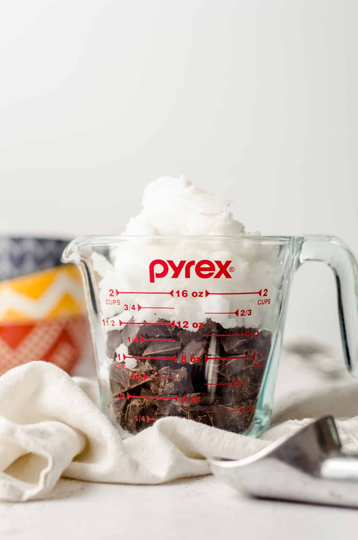 chopped chocolate and coconut oil in a glass measuring cup to make homemade magic shell