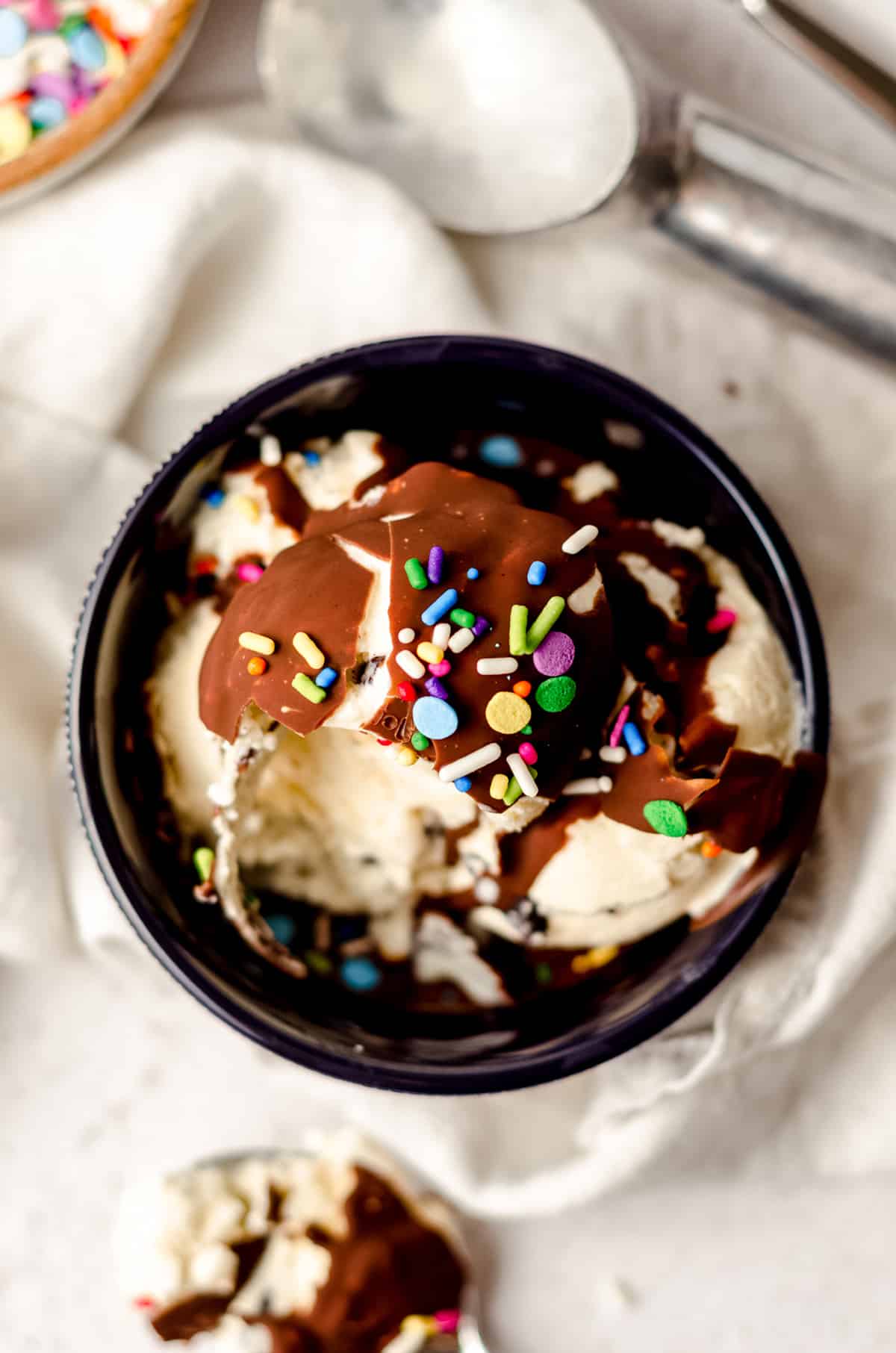 aerial photo of magic shell on a bowl of ice cream with sprinkles