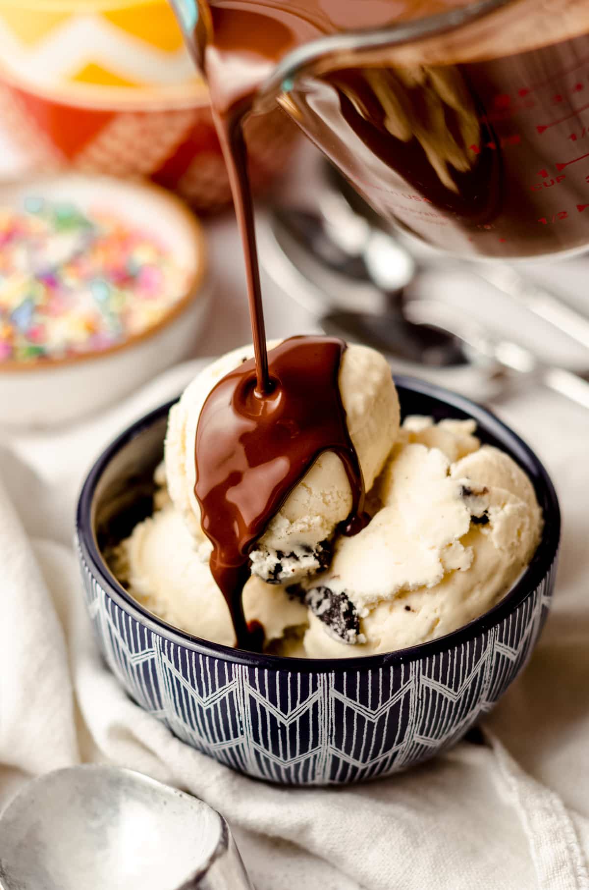 pouring homemade magic shell onto a bowl of ice cream