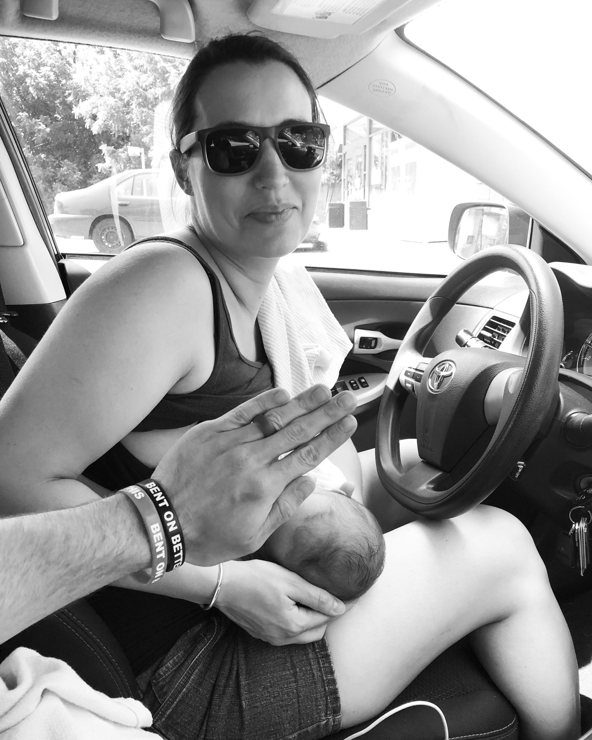 a woman breastfeeding in a car