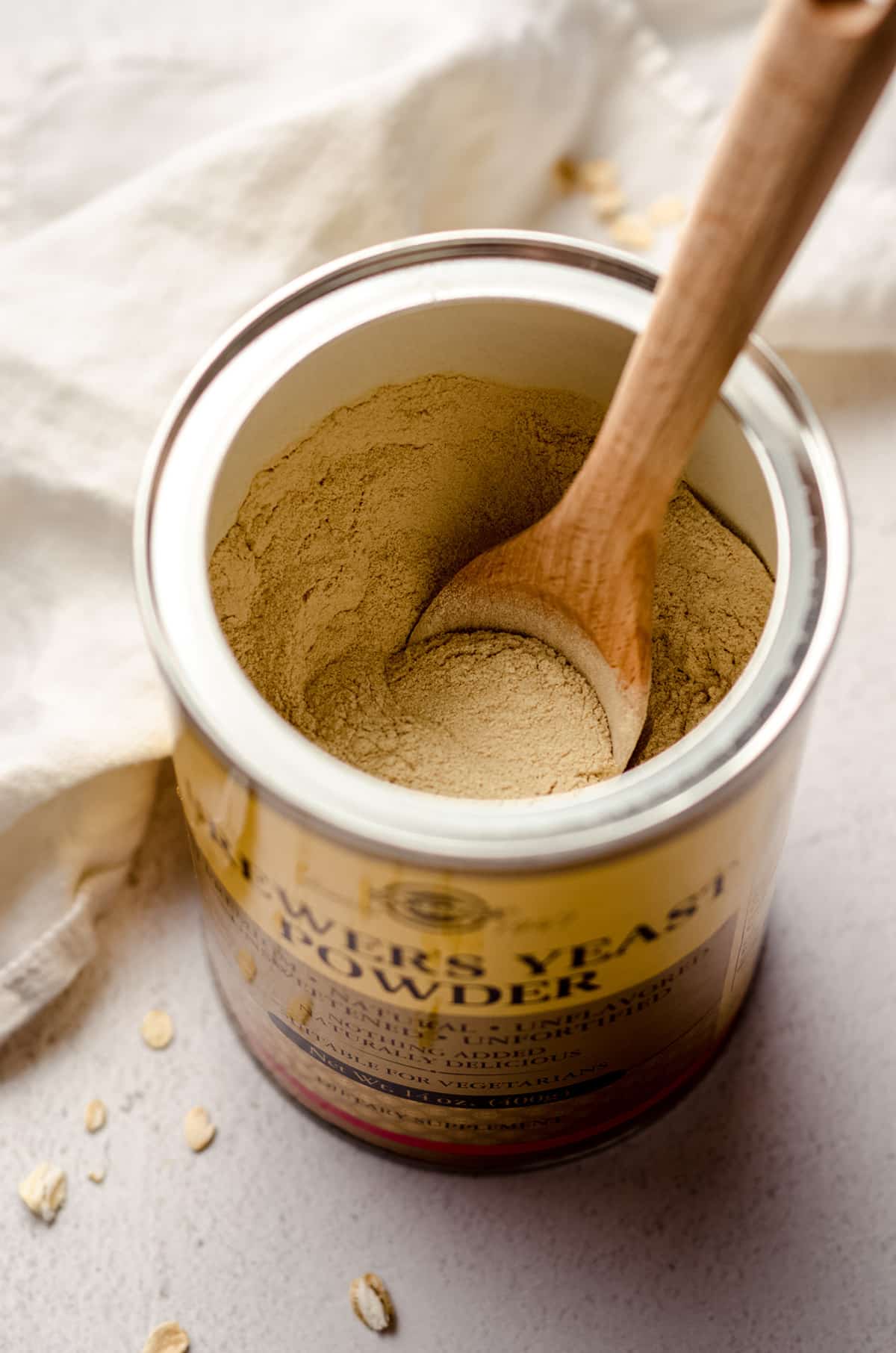 can of brewer's yeast with a wooden spoon in it