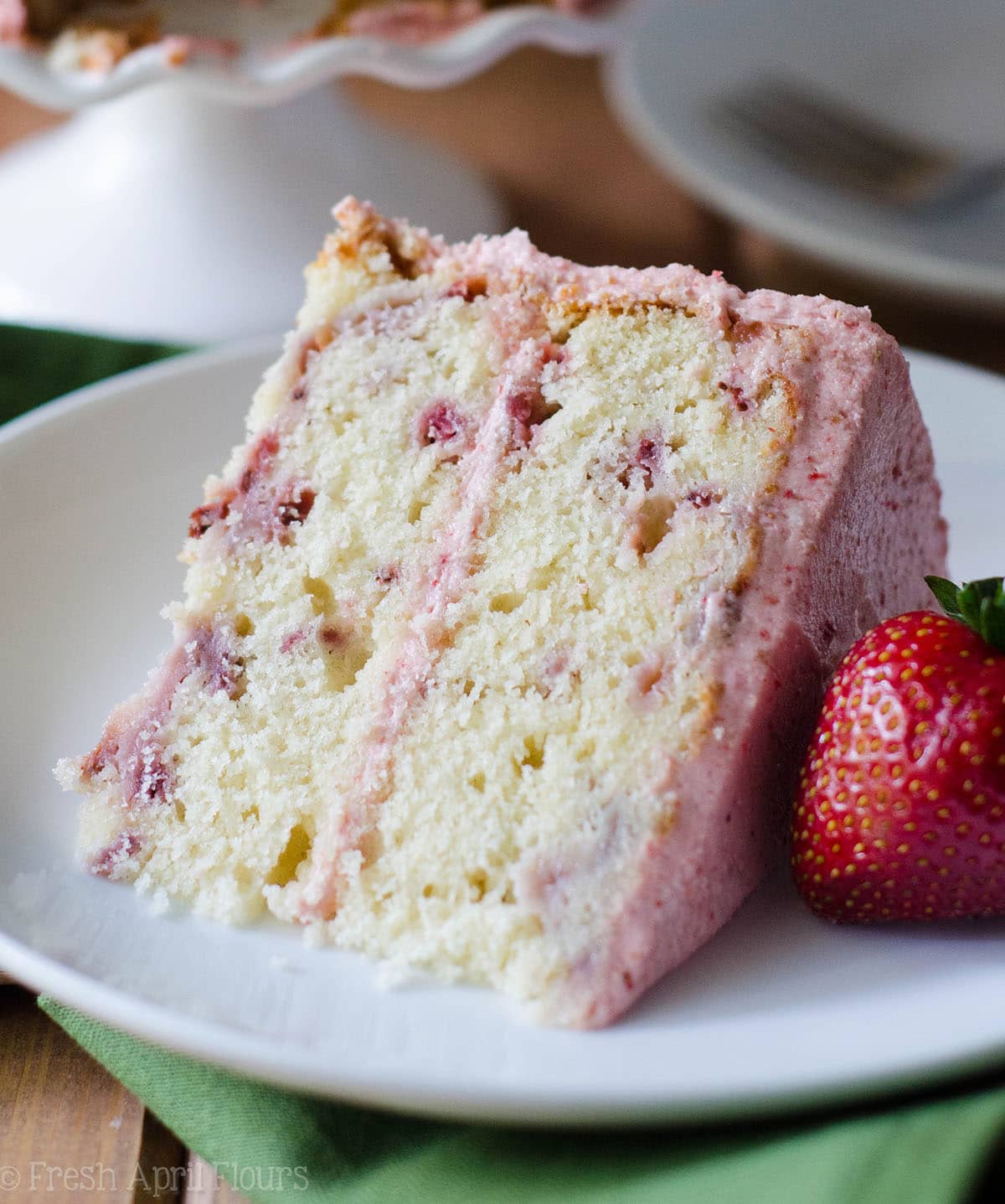 slice of fresh strawberry cake on a plate